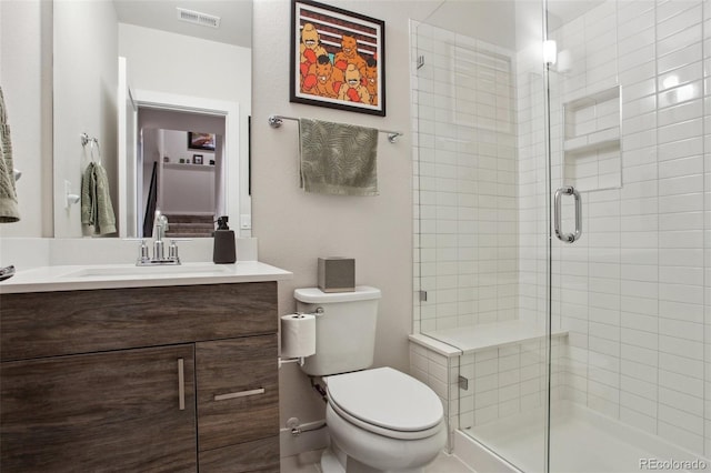 full bathroom with toilet, visible vents, vanity, and a stall shower