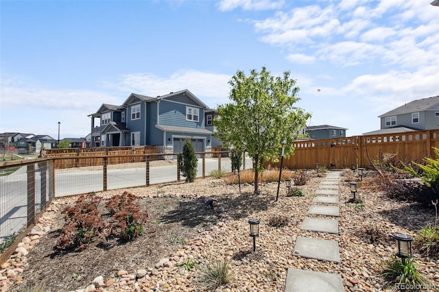 view of yard featuring a residential view and fence