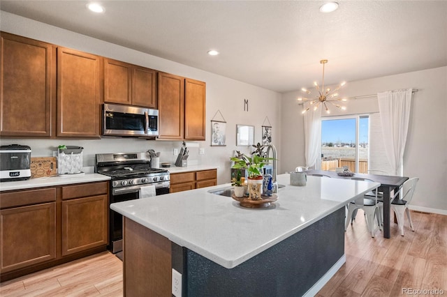 244 Chipeta Way, Lochbuie, CO 80603 - kitchen featuring appliances with stainless steel finishes, light wood-style flooring, light countertops, and recessed lighting