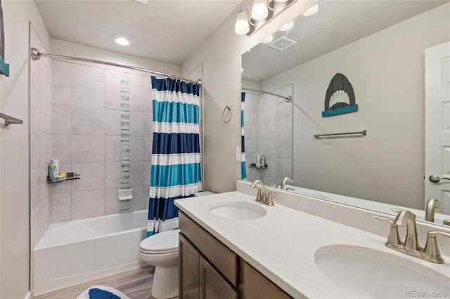 244 Chipeta Way, Lochbuie, CO 80603 - full bath with toilet, shower / tub combo with curtain, wood finished floors, double vanity, and recessed lighting