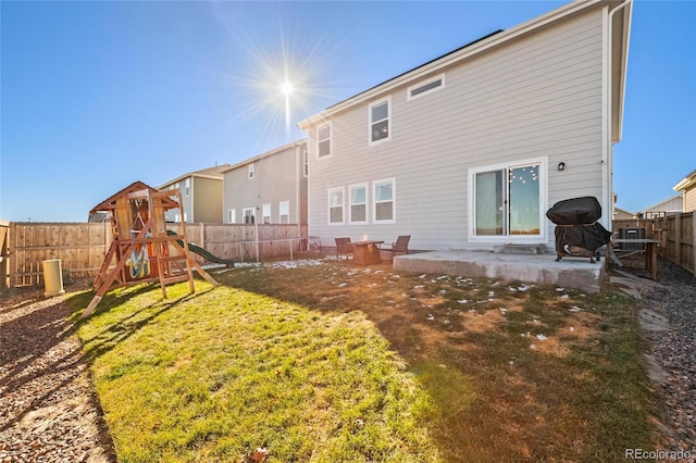 244 Chipeta Way, Lochbuie, CO 80603 - back of house featuring a playground and a patio