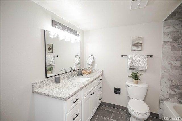 bathroom with tile patterned flooring, vanity, and toilet