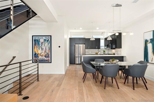 dining space with light hardwood / wood-style floors