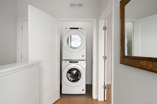 laundry room featuring stacked washer / drying machine