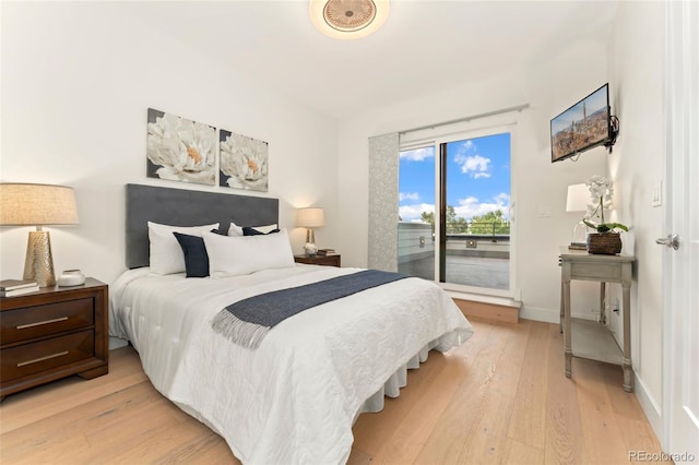 bedroom featuring light wood-type flooring and access to outside