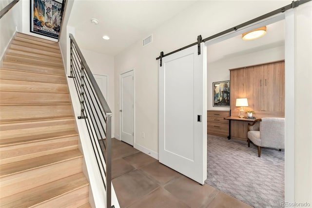 staircase featuring a barn door