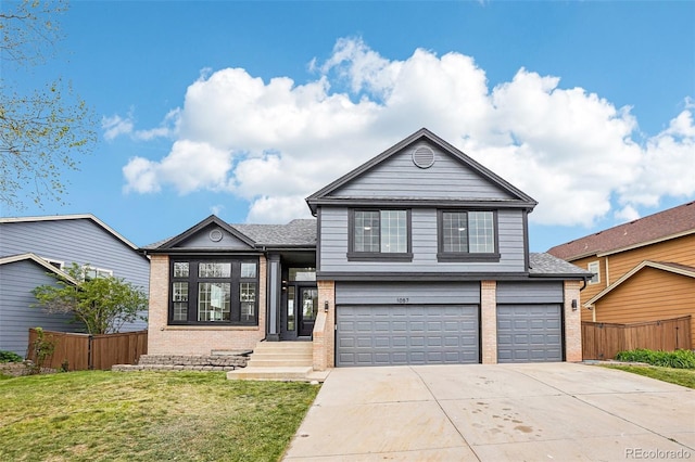 1057 English Sparrow Trl, Highlands Ranch, CO 80129 - tri-level home featuring fence, an attached garage, brick siding, a front yard, and driveway