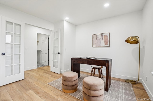 living area with french doors, recessed lighting, light wood-style floors, and baseboards