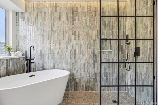 1057 English Sparrow Trl, Highlands Ranch, CO 80129 - full bath with a freestanding tub, tile walls, and walk in shower