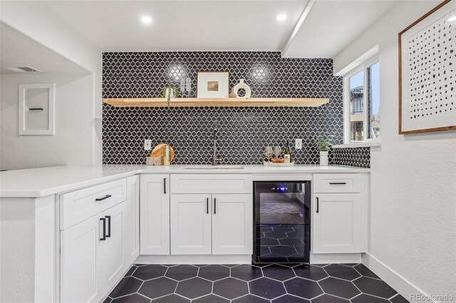 1057 English Sparrow Trl, Highlands Ranch, CO 80129 - bar featuring beverage cooler, a sink, decorative backsplash, and indoor wet bar