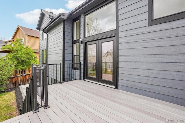 deck featuring french doors and fence