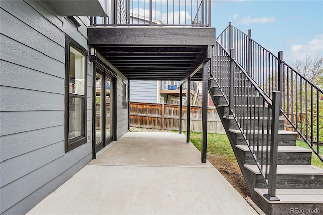 view of patio / terrace with fence and stairs