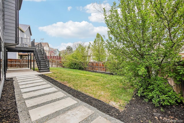 view of yard featuring stairs and a fenced backyard