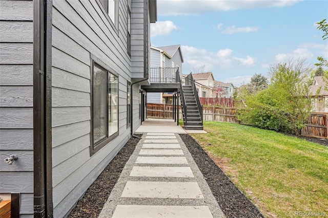 view of yard featuring stairway, a residential view, and a fenced backyard
