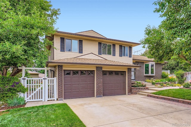 1729 S Ouray Ct, Aurora, CO 80017 - tri-level home featuring driveway, an attached garage, brick siding, and a gate