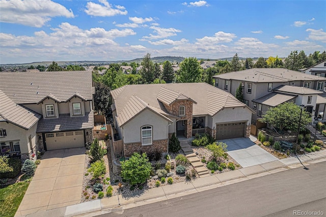10994 Shadowbrook Cir, Highlands Ranch, CO 80130 - view of front of house with driveway, stone siding, a residential view, and stucco siding