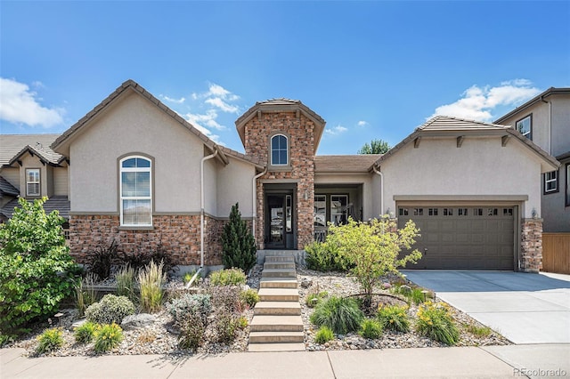 10994 Shadowbrook Cir, Highlands Ranch, CO 80130 - view of front of house featuring stucco siding, stone siding, driveway, and an attached garage