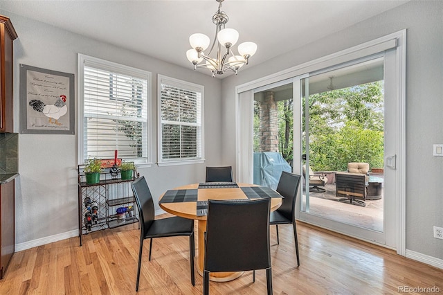 10994 Shadowbrook Cir, Highlands Ranch, CO 80130 - dining space featuring a chandelier and light wood-style flooring