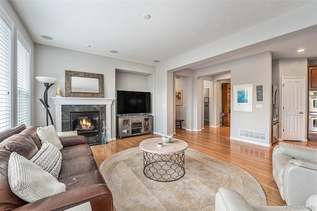 10994 Shadowbrook Cir, Highlands Ranch, CO 80130 - living room featuring a fireplace, light wood finished floors, and recessed lighting