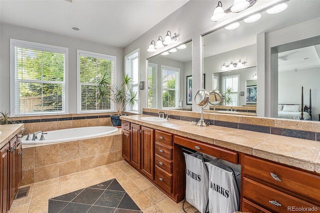 10994 Shadowbrook Cir, Highlands Ranch, CO 80130 - bathroom with vanity, a bath, stone tile flooring, and ensuite bathroom