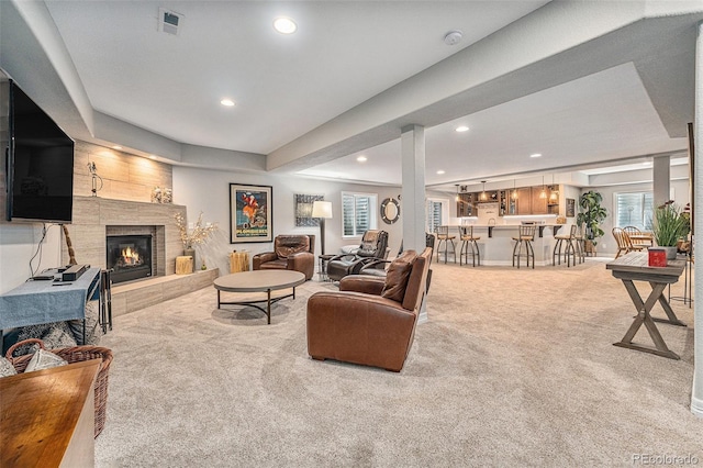 10994 Shadowbrook Cir, Highlands Ranch, CO 80130 - living area with carpet flooring, a lit fireplace, recessed lighting, and bar area