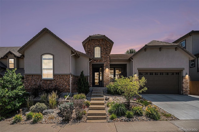 10994 Shadowbrook Cir, Highlands Ranch, CO 80130 - view of front of house with stone siding, stucco siding, driveway, and an attached garage