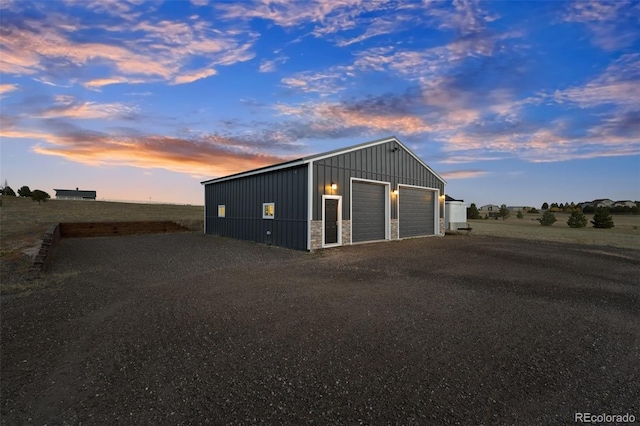 view of garage at dusk