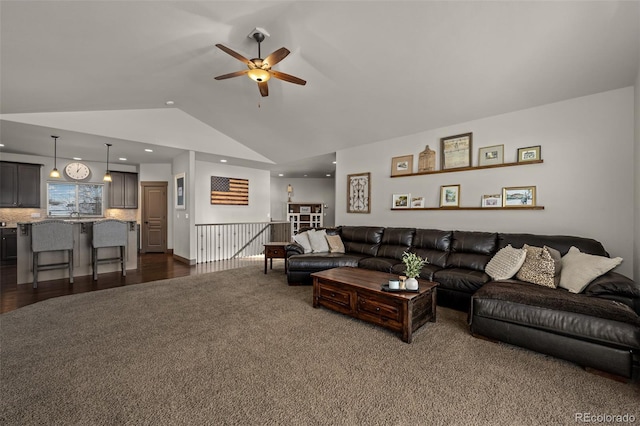 living room with dark colored carpet, ceiling fan, and lofted ceiling