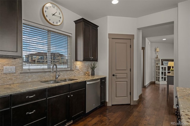 kitchen with dishwasher, sink, dark hardwood / wood-style floors, decorative backsplash, and light stone countertops