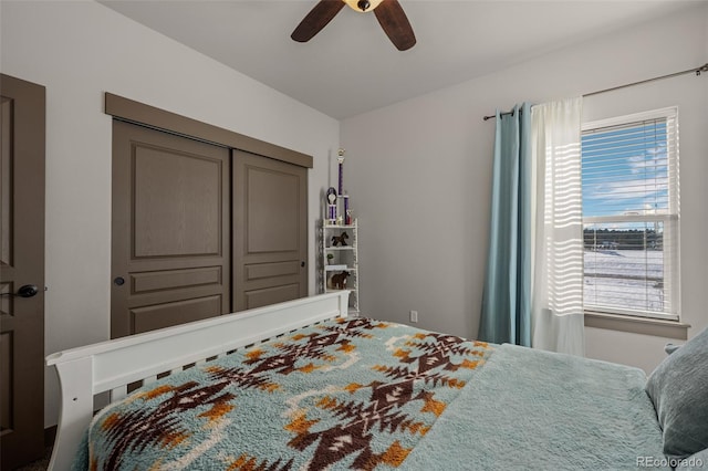 bedroom with ceiling fan and a closet