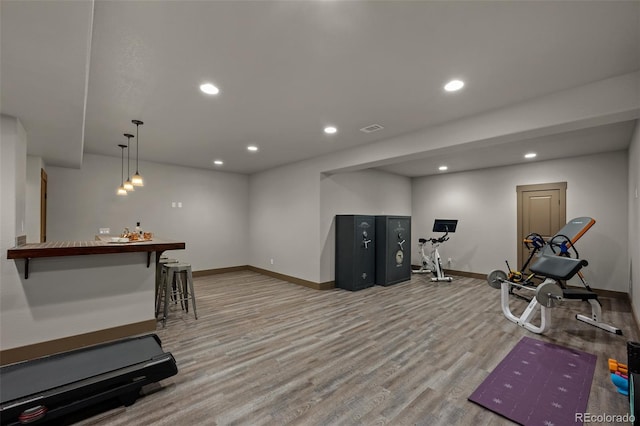 exercise room featuring light wood-type flooring