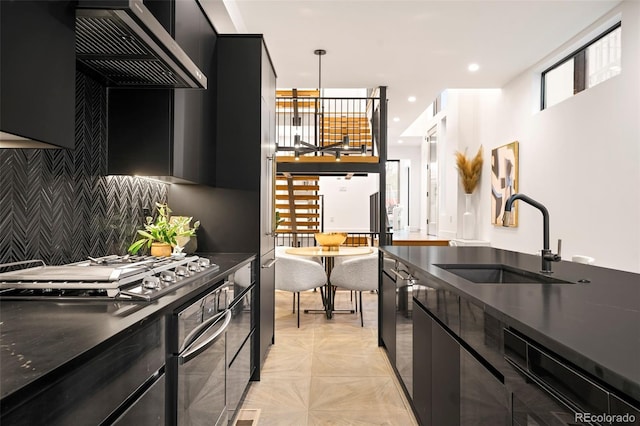 kitchen featuring pendant lighting, appliances with stainless steel finishes, sink, and a wealth of natural light