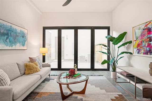 living room featuring wood-type flooring and ceiling fan