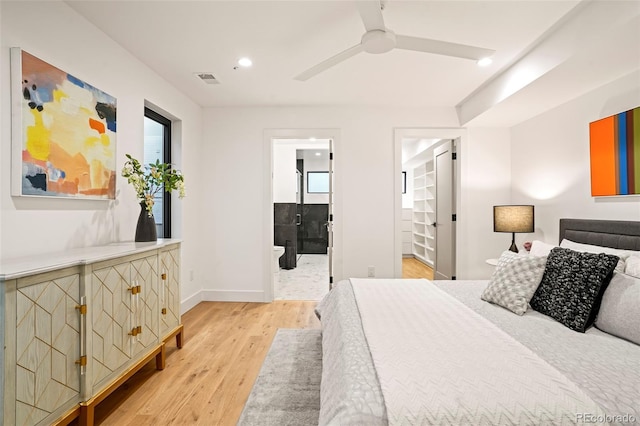 bedroom featuring light wood-type flooring, ensuite bath, and ceiling fan