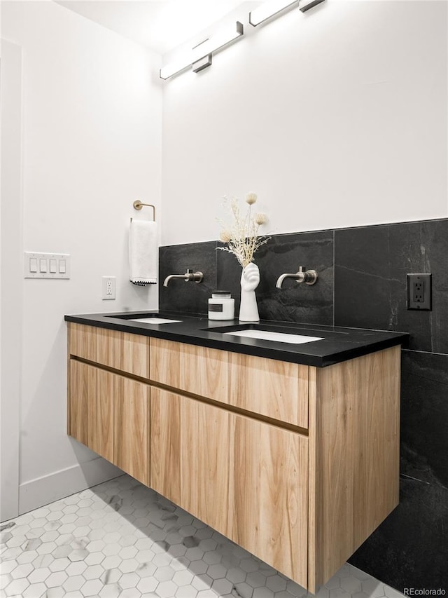 bathroom featuring backsplash, tile patterned flooring, and vanity