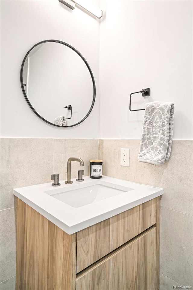 bathroom with vanity and tile walls