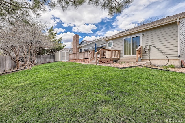 6376 S Pierson St, Littleton, CO 80127 - view of yard featuring a wooden deck, a storage unit, and an outbuilding
