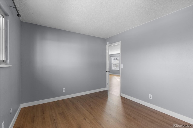 empty room featuring hardwood / wood-style floors and a textured ceiling