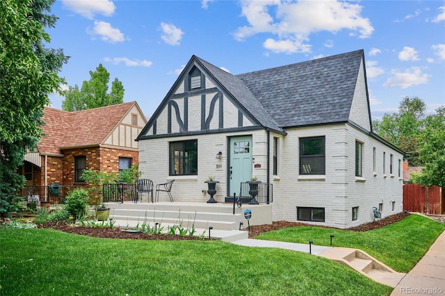 english style home featuring a front yard