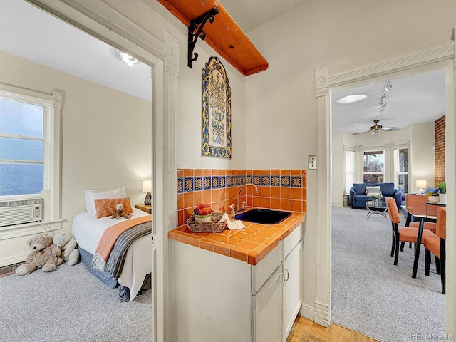 interior space featuring light colored carpet, cooling unit, and a sink