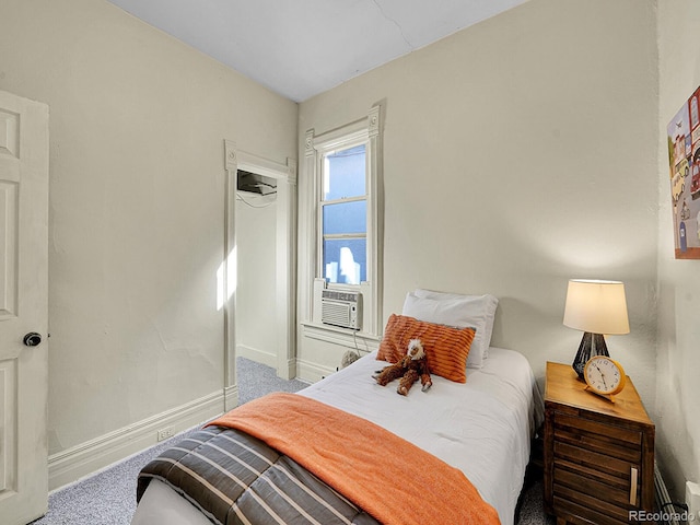 bedroom with cooling unit, baseboards, and carpet flooring