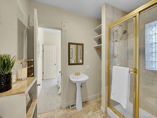 full bathroom featuring baseboards and a stall shower