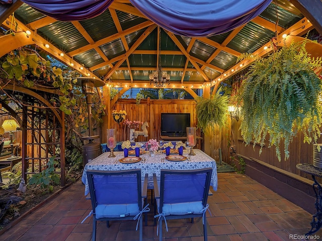 view of patio with outdoor dining space, a gazebo, and fence