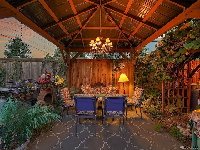 view of patio / terrace with a gazebo, outdoor dining area, and fence