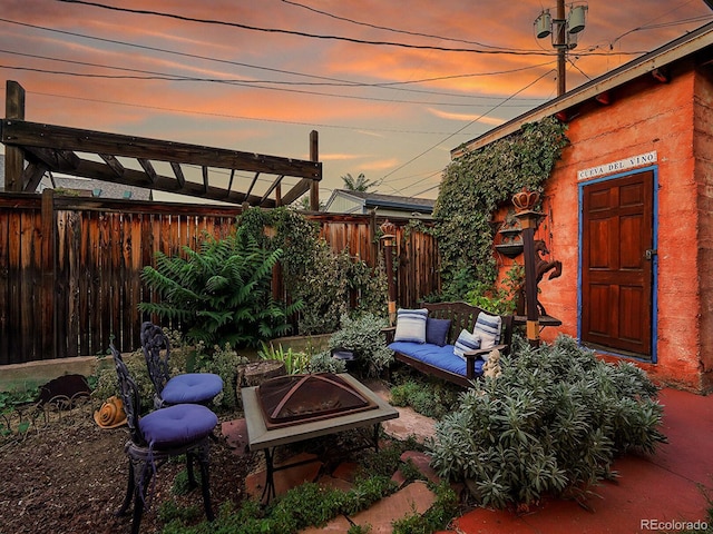 view of patio / terrace with an outdoor fire pit and fence