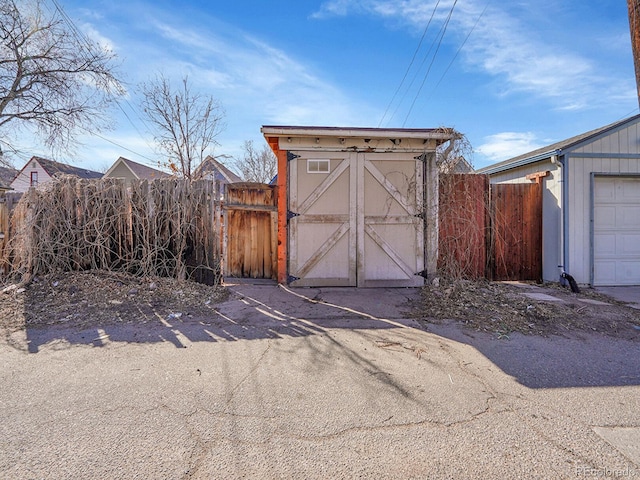 view of shed featuring fence