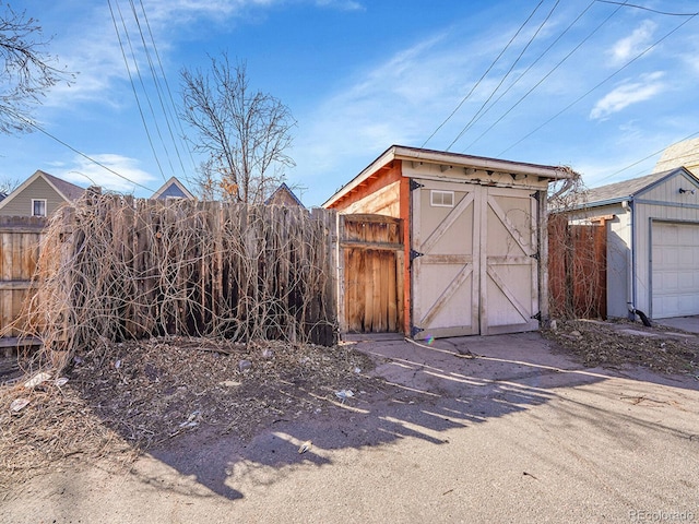 view of shed featuring fence