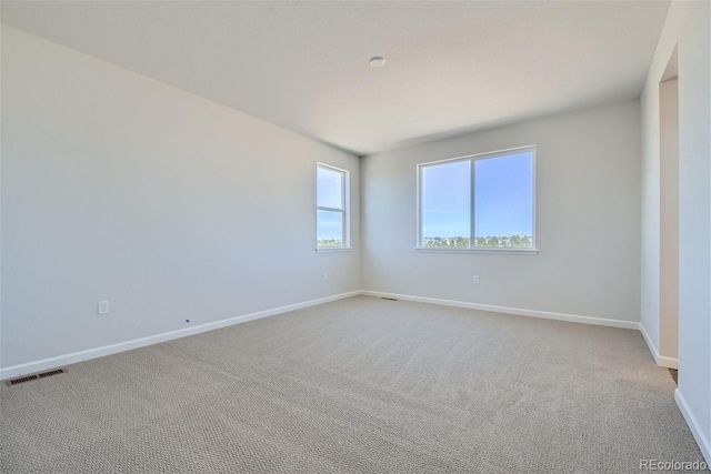 unfurnished room featuring light colored carpet