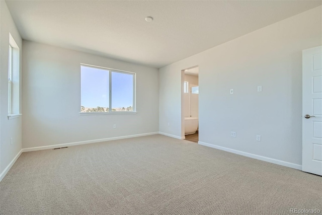 empty room with light colored carpet