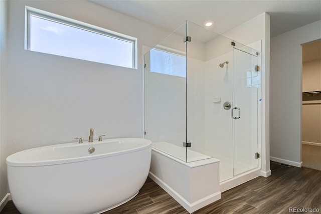 bathroom featuring hardwood / wood-style floors and shower with separate bathtub